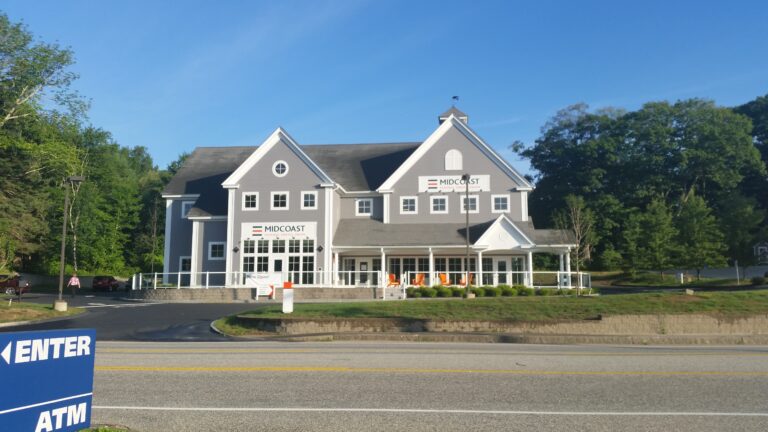 Front of Midcoast Federal Credit Union with porch and orange adirondack chairs