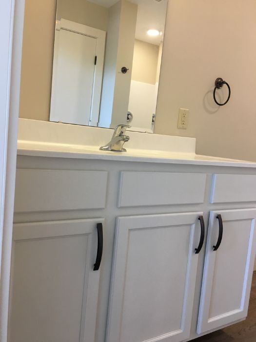 white cabinets and mirror