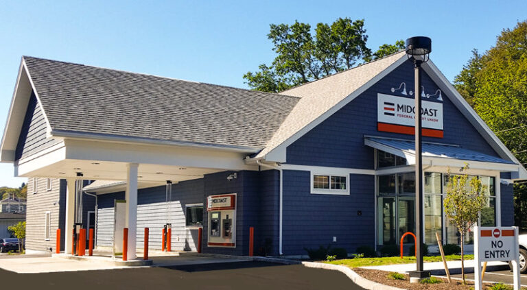 Exterior of Midcoast building with logo and dark blue siding and drive through